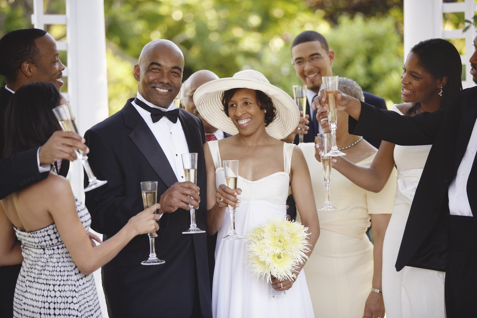 Wedding celebration with champagne toast surrounded by family and friends